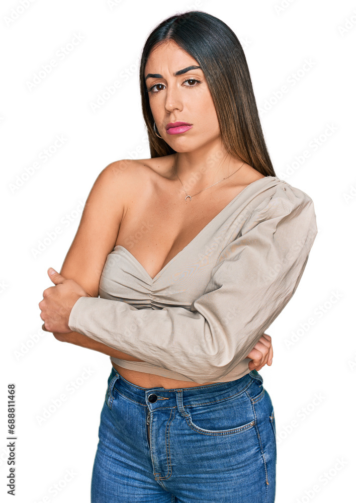 Young hispanic woman wearing casual clothes skeptic and nervous, disapproving expression on face with crossed arms. negative person. Young hispanic woman wearing casual clothes skeptic and nervous, disapproving expression on face with crossed arms. negative person.