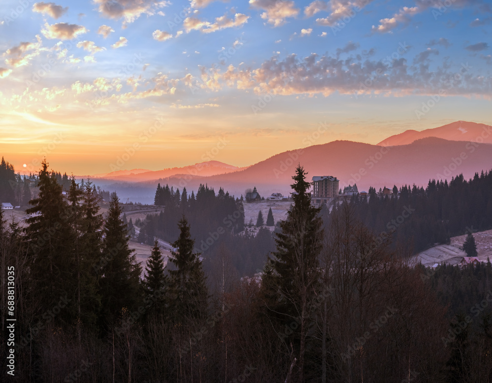 Picturesque sunrise above late autumn mountain countryside.  Ukraine, Carpathian Mountains. Peaceful traveling, seasonal, nature and countryside beauty concept scene.