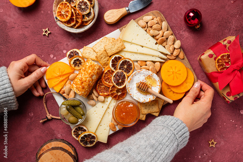 Holiday cheese board assortment with nuts and gifts photo