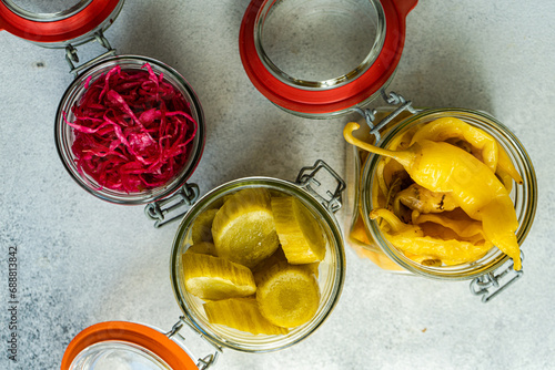 Variety of fermented vegetables in glass jars photo