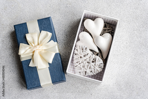 Blue Gift Box with Heart Ornaments Generative AI photo