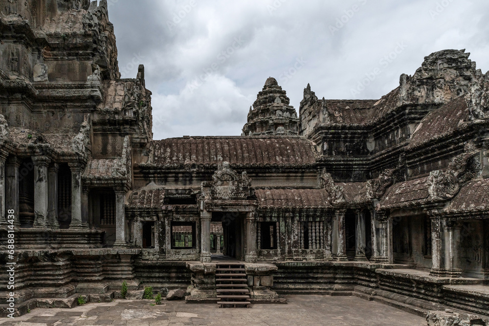 Ancient temple ruins under overcast sky in Angkor Wat complex Ancient temple ruins under overcast sky in Angkor Wat complex