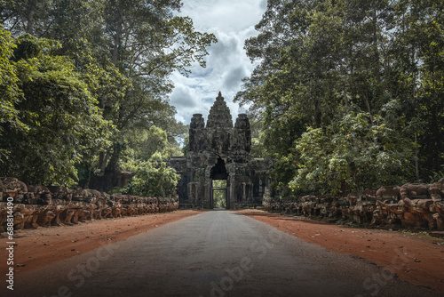 Mystical Angkor Thom Gate Amidst Lush Cambodian Forest photo