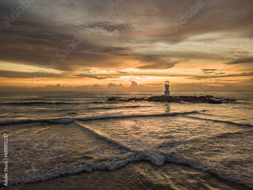 sunset on the beach with lighthouse
