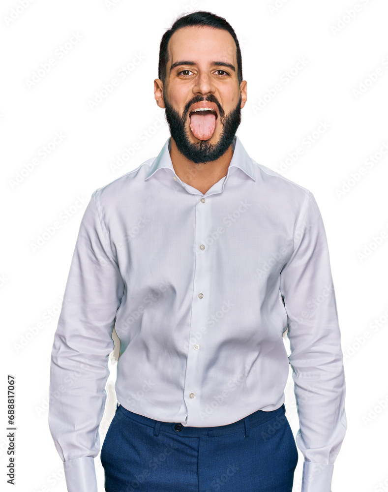 Young man with beard wearing business shirt sticking tongue out happy with funny expression. emotion concept. Young man with beard wearing business shirt sticking tongue out happy with funny expression. emotion concept.