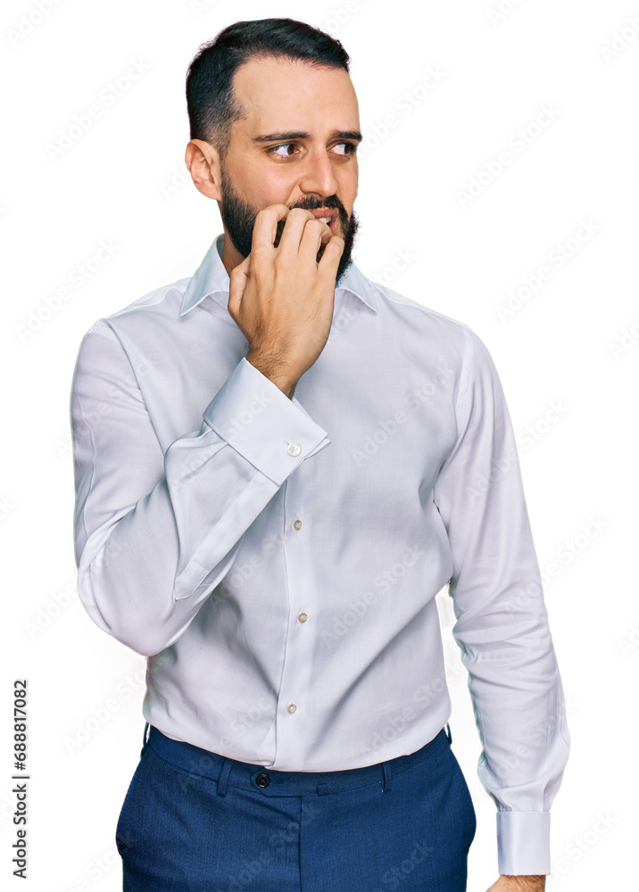 Young man with beard wearing business shirt looking stressed and nervous with hands on mouth biting nails. anxiety problem. Young man with beard wearing business shirt looking stressed and nervous with hands on mouth biting nails. anxiety problem.