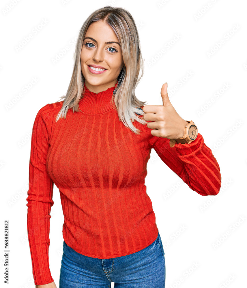 Beautiful blonde woman wearing casual clothes doing happy thumbs up gesture with hand. approving expression looking at the camera showing success. Beautiful blonde woman wearing casual clothes doing happy thumbs up gesture with hand. approving expression looking at the camera showing success.