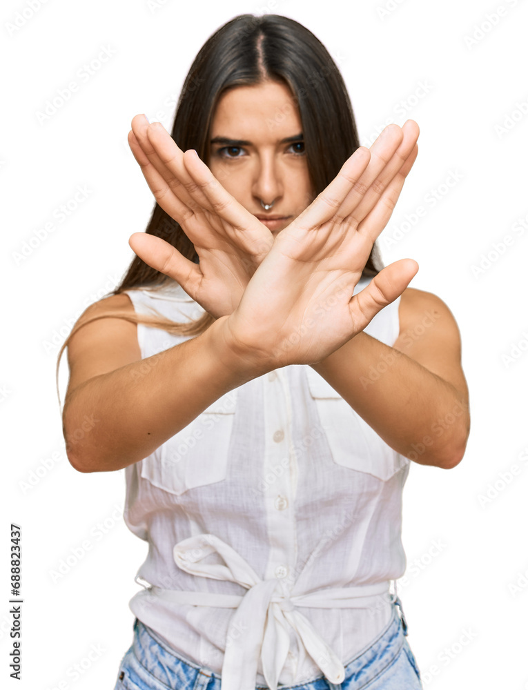 Young hispanic woman wearing casual clothes rejection expression crossing arms and palms doing negative sign, angry face Young hispanic woman wearing casual clothes rejection expression crossing arms and palms doing negative sign, angry face