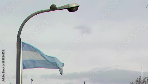 An Ovenbird Nest on a Lamppost with the Argentine Flag, Buenos Aires, Argentina. photo