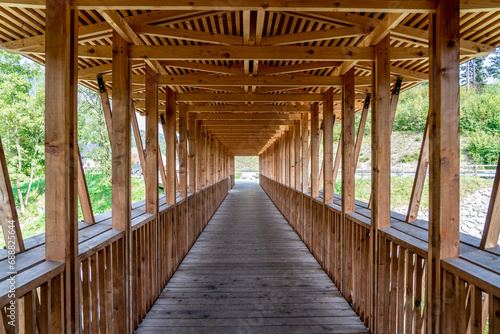 Symmetrical picture of a wooden bridge over a river, Slovenia