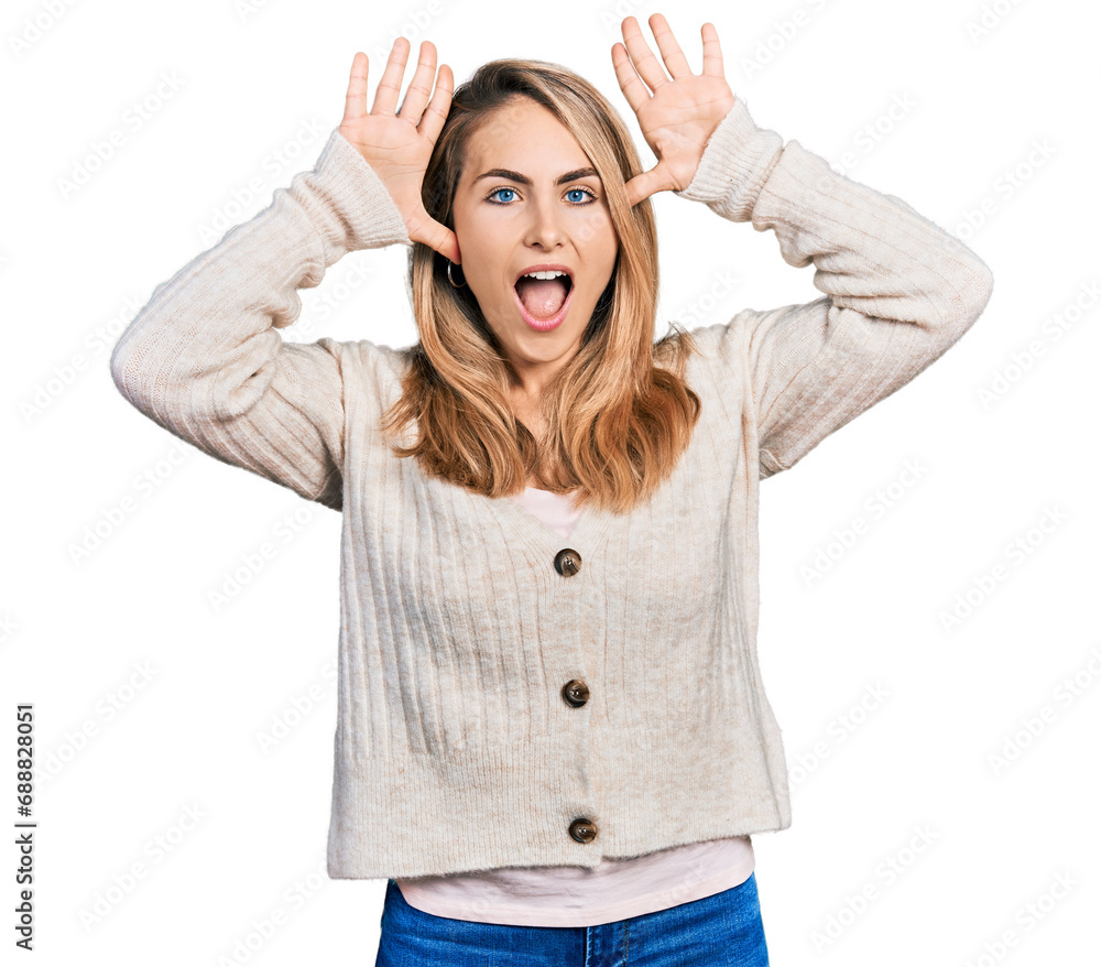 Young blonde woman wearing casual clothes smiling cheerful playing peek a boo with hands showing face. surprised and exited Young blonde woman wearing casual clothes smiling cheerful playing peek a boo with hands showing face. surprised and exited