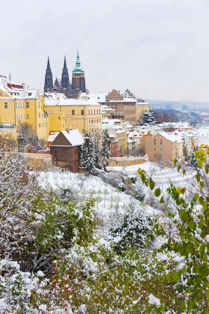 Obraz premium Snowy Prague City with gothic Castle from the Hill Petrin, Czech republic