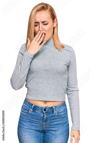 Beautiful caucasian woman wearing casual clothes bored yawning tired covering mouth with hand. restless and sleepiness.