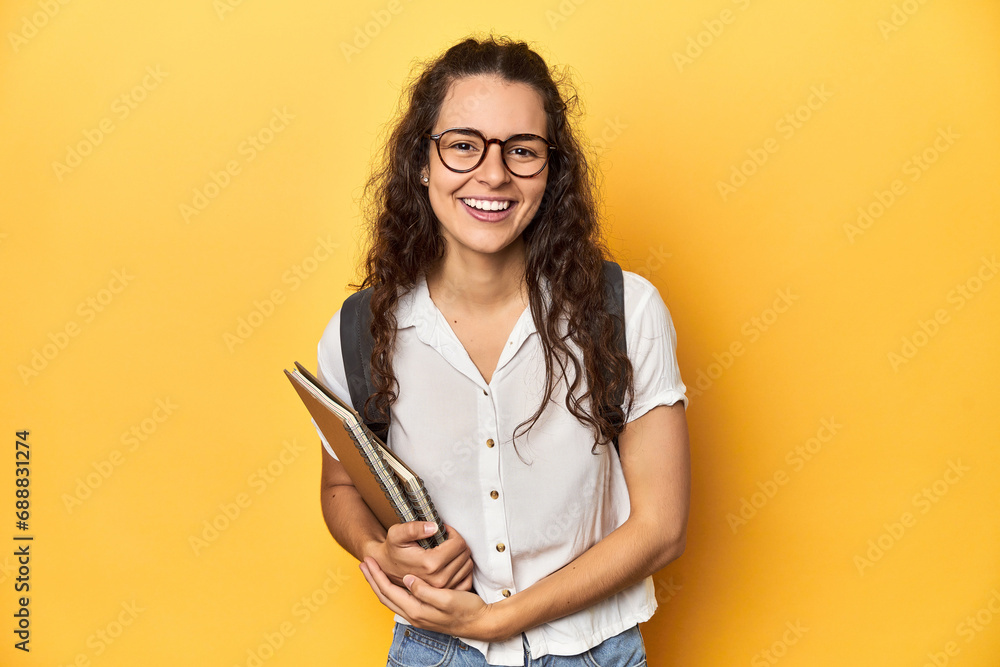 Student holding notebooks, glasses, backpack on, laughing and having fun. Student holding notebooks, glasses, backpack on, laughing and having fun.