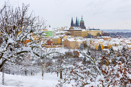 Snowy Prague City with gothic Castle from the Hill Petrin, Czech republic