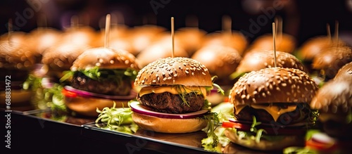 Mini hamburgers at catering event, in close view.