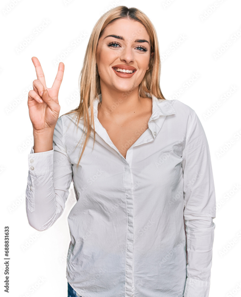 Young caucasian woman wearing casual clothes showing and pointing up with fingers number two while smiling confident and happy. Young caucasian woman wearing casual clothes showing and pointing up with fingers number two while smiling confident and happy.