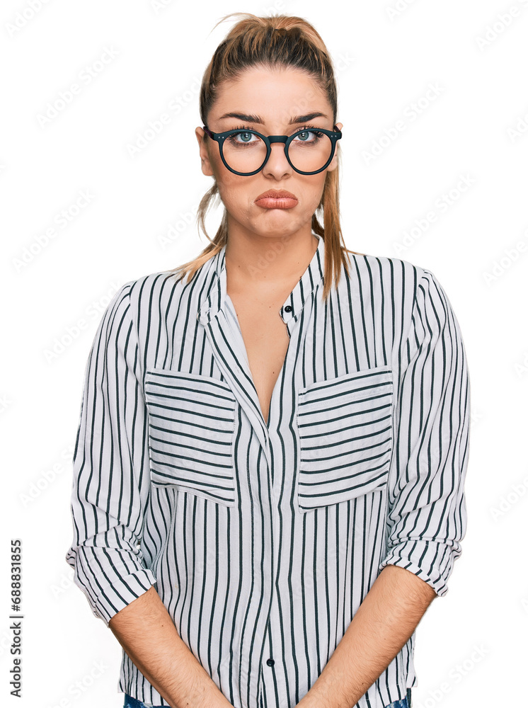 Young caucasian woman wearing business shirt and glasses depressed and worry for distress, crying angry and afraid. sad expression. Young caucasian woman wearing business shirt and glasses depressed and worry for distress, crying angry and afraid. sad expression.