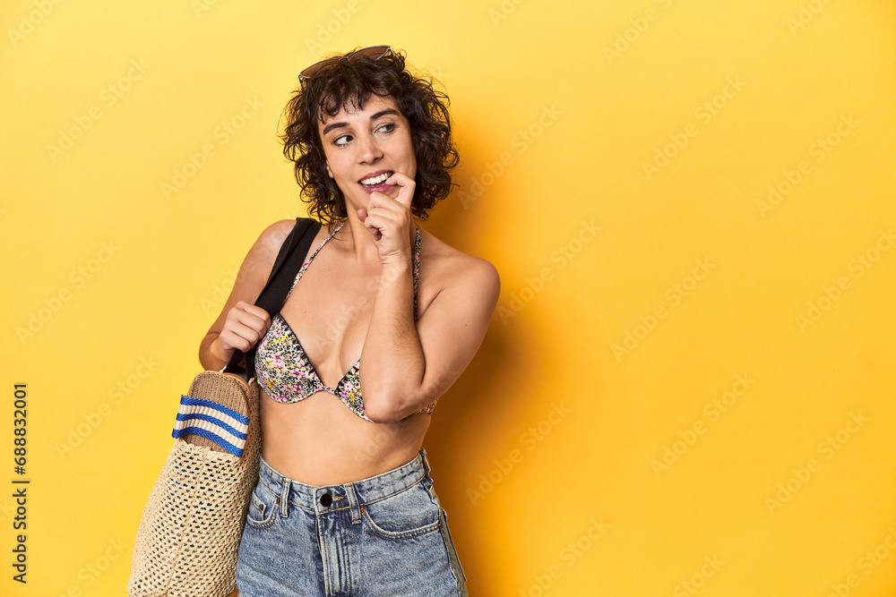 Caucasian woman in bikini with beach bag, studio relaxed thinking about something looking at a copy space. Caucasian woman in bikini with beach bag, studio relaxed thinking about something looking at a copy space.