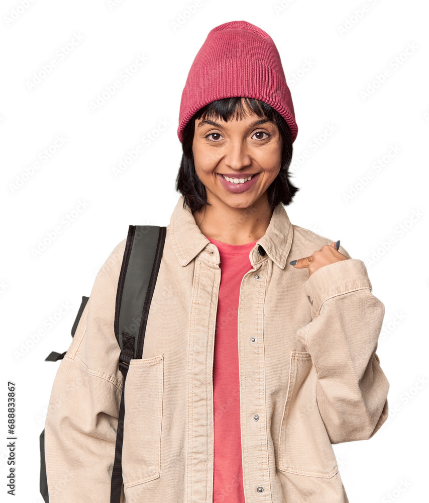 Young student with backpack and beanie in studio keeping a secret or asking for silence. Young student with backpack and beanie in studio keeping a secret or asking for silence.