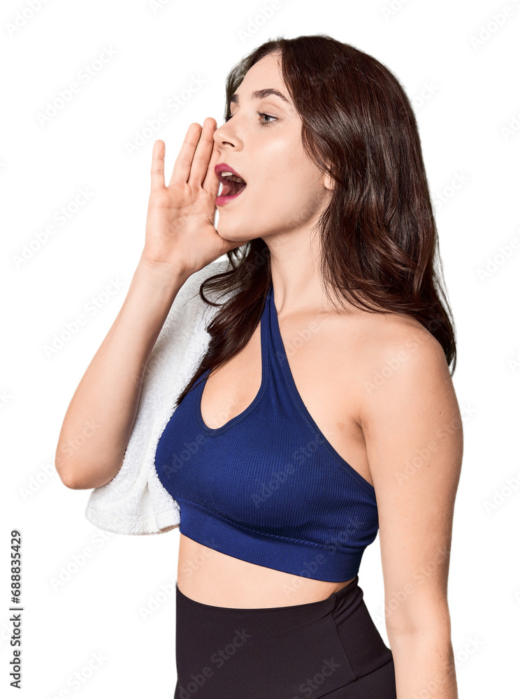 Athletic young Caucasian woman with towel in studio shouting and holding palm near opened mouth. Athletic young Caucasian woman with towel in studio shouting and holding palm near opened mouth.