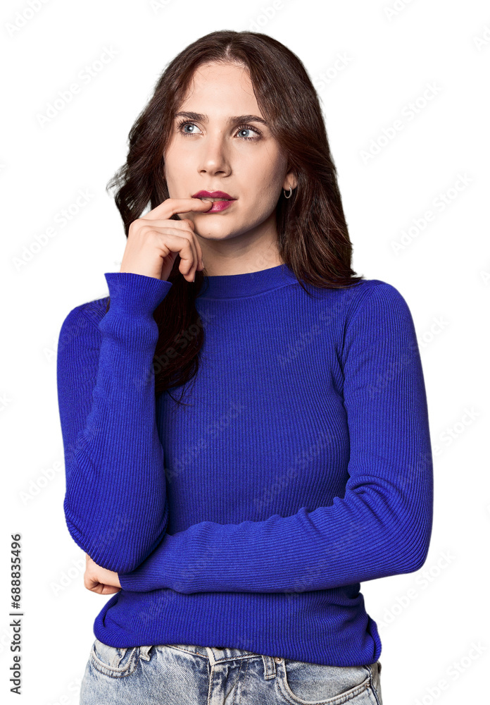 Young Caucasian woman in a studio setting looking sideways with doubtful and skeptical expression. Young Caucasian woman in a studio setting looking sideways with doubtful and skeptical expression.
