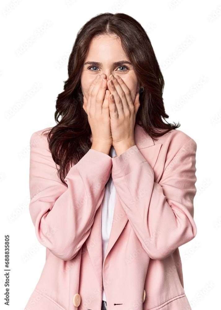 Young Caucasian woman in a studio setting laughing about something, covering mouth with hands. Young Caucasian woman in a studio setting laughing about something, covering mouth with hands.