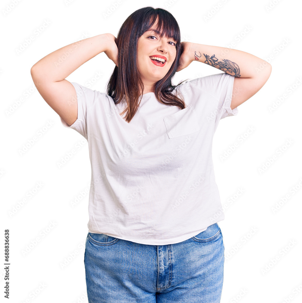 Young plus size woman wearing casual clothes relaxing and stretching, arms and hands behind head and neck smiling happy Young plus size woman wearing casual clothes relaxing and stretching, arms and hands behind head and neck smiling happy