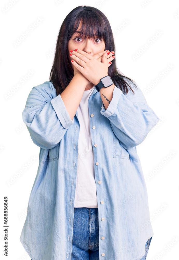 Young plus size woman wearing casual clothes shocked covering mouth with hands for mistake. secret concept. Young plus size woman wearing casual clothes shocked covering mouth with hands for mistake. secret concept.