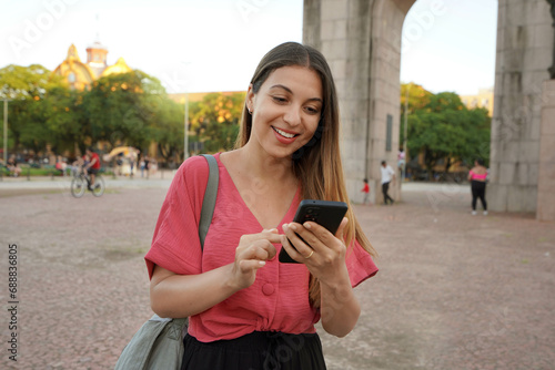 Smiling Brazilian girl using smartphone in Porto Alegre, Rio Grande do Sul, Brazil