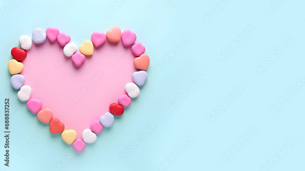 Heart made of colorful candy on a blue background.  Valentine's Day, BIrthday concept.