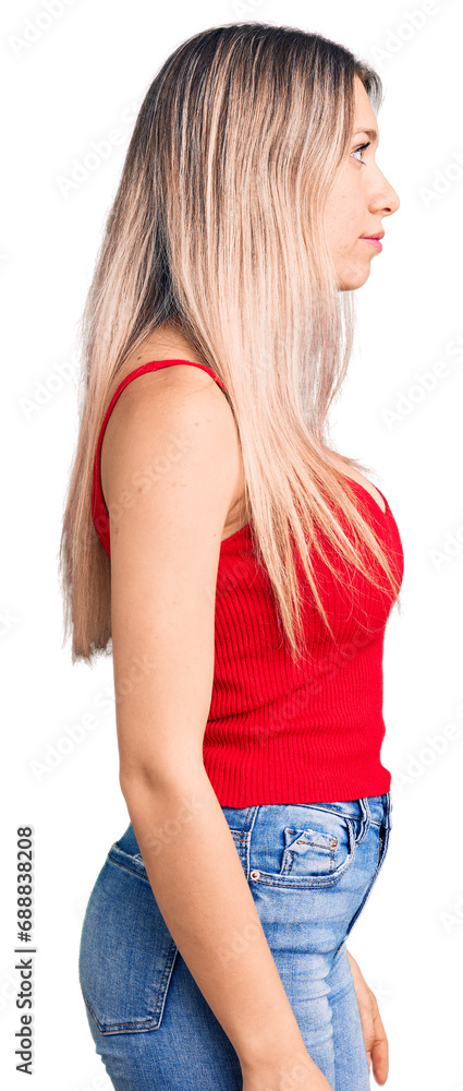 Young beautiful blonde woman wearing casual clothes looking to side, relax profile pose with natural face with confident smile. Young beautiful blonde woman wearing casual clothes looking to side, relax profile pose with natural face with confident smile.