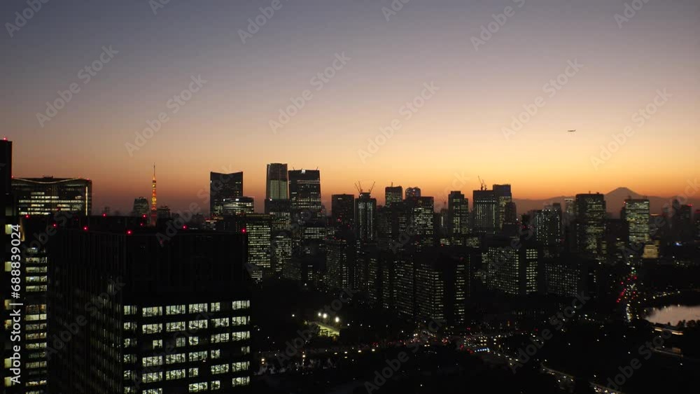 TOKYO, JAPAN - NOV 2023 : Aerial high angle view of cityscape of Tokyo and Mount Fuji in sunset. View of office buildings around Tokyo station and Nagatacho area. TOKYO, JAPAN - NOV 2023 : Aerial high angle view of cityscape of Tokyo and Mount Fuji in sunset. View of office buildings around Tokyo station and Nagatacho area.