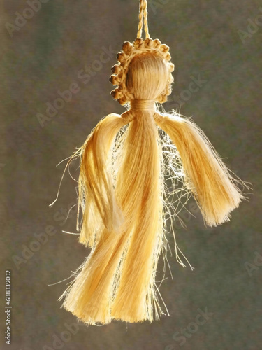 Принти на полотні A hanging twine angel glowing from back-light against a grey background