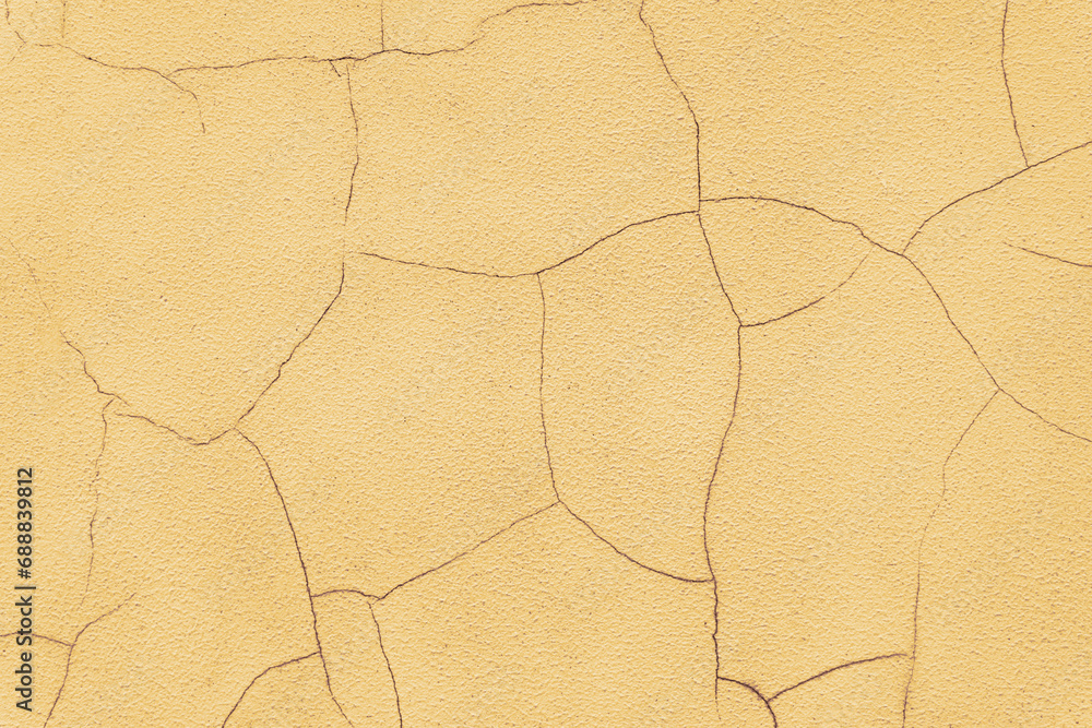 Old stucco plaster surface with cracks, close up grunge texture of yellow painted cement, concrete wall texture background. Wallpaper, backdrop, architecture design element Old stucco plaster surface with cracks, close up grunge texture of yellow painted cement, concrete wall texture background. Wallpaper, backdrop, architecture design element