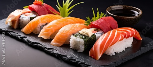 Traditional Japanese sushi presented on a stone platter. photo