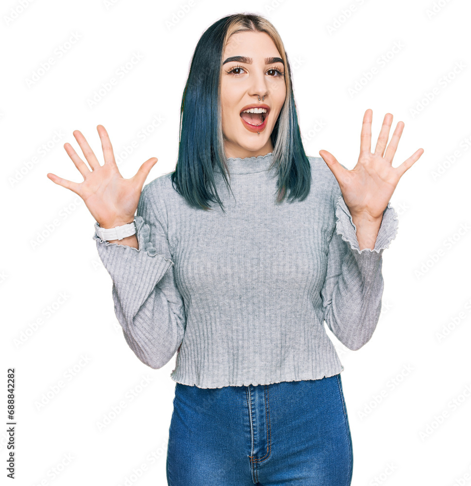 Young modern girl wearing casual sweater showing and pointing up with fingers number ten while smiling confident and happy. Young modern girl wearing casual sweater showing and pointing up with fingers number ten while smiling confident and happy.