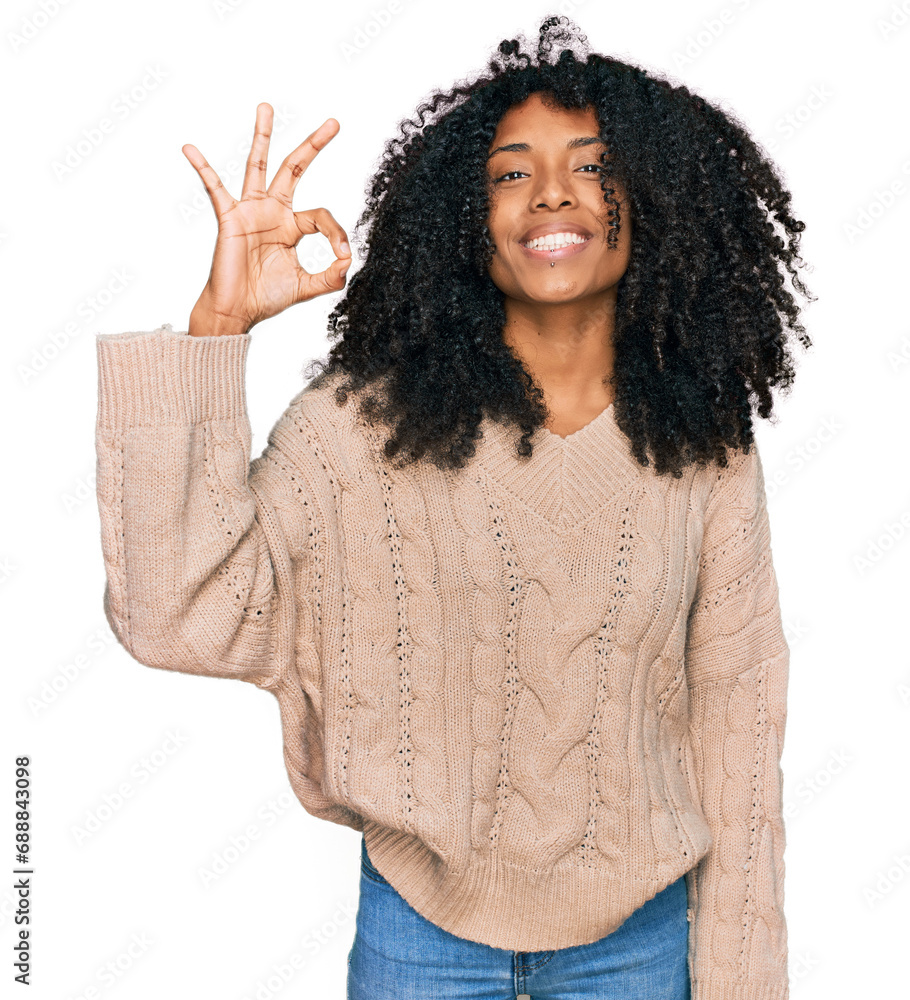 Young african american girl wearing casual clothes smiling positive doing ok sign with hand and fingers. successful expression. Young african american girl wearing casual clothes smiling positive doing ok sign with hand and fingers. successful expression.