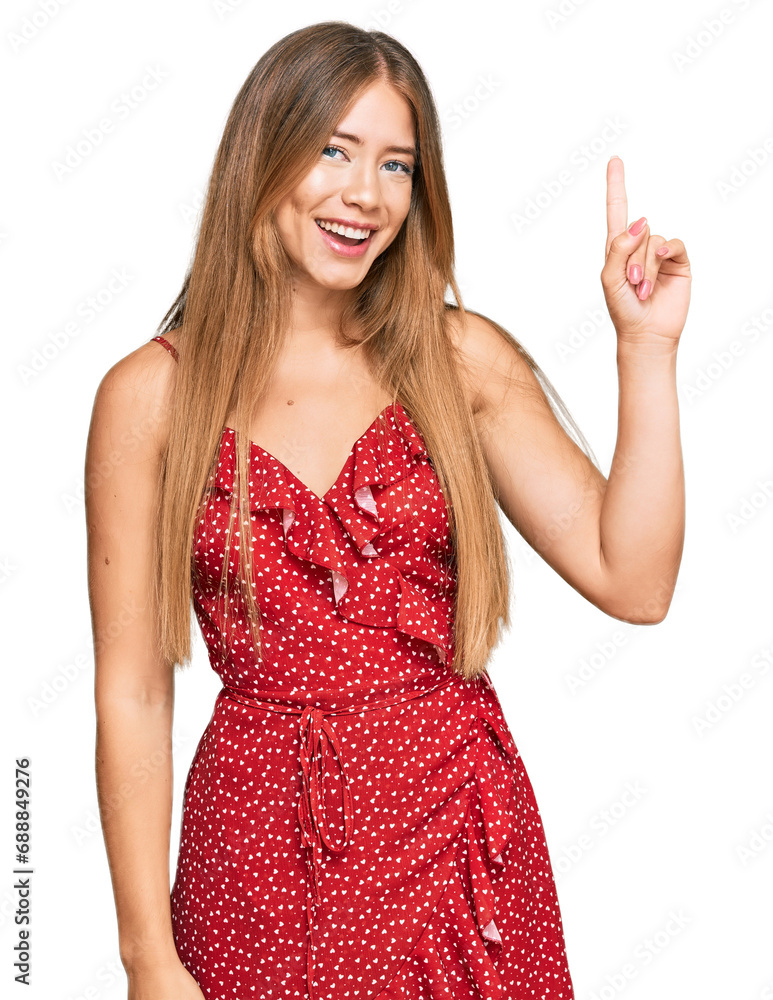 Beautiful blonde woman wearing summer dress showing and pointing up with finger number one while smiling confident and happy. Beautiful blonde woman wearing summer dress showing and pointing up with finger number one while smiling confident and happy.