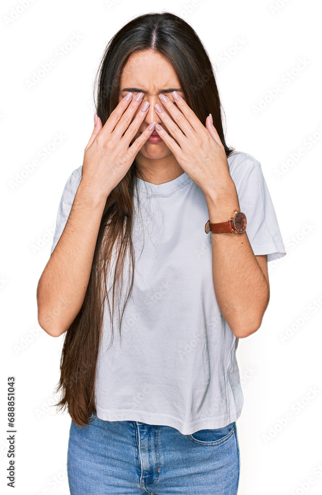 Young hispanic girl wearing casual white t shirt rubbing eyes for fatigue and headache, sleepy and tired expression. vision problem Young hispanic girl wearing casual white t shirt rubbing eyes for fatigue and headache, sleepy and tired expression. vision problem