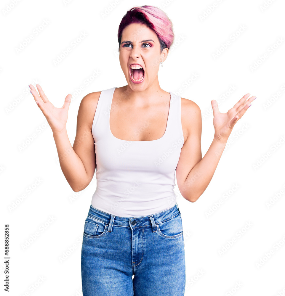 Young beautiful woman with pink hair wearing casual clothes crazy and mad shouting and yelling with aggressive expression and arms raised. frustration concept. Young beautiful woman with pink hair wearing casual clothes crazy and mad shouting and yelling with aggressive expression and arms raised. frustration concept.