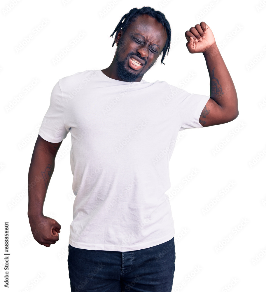 Young african american man with braids wearing casual white tshirt stretching back, tired and relaxed, sleepy and yawning for early morning Young african american man with braids wearing casual white tshirt stretching back, tired and relaxed, sleepy and yawning for early morning