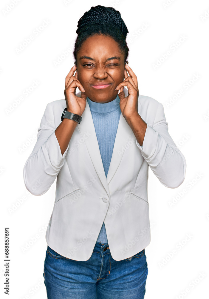 Young african american woman wearing business clothes covering ears with fingers with annoyed expression for the noise of loud music. deaf concept. Young african american woman wearing business clothes covering ears with fingers with annoyed expression for the noise of loud music. deaf concept.