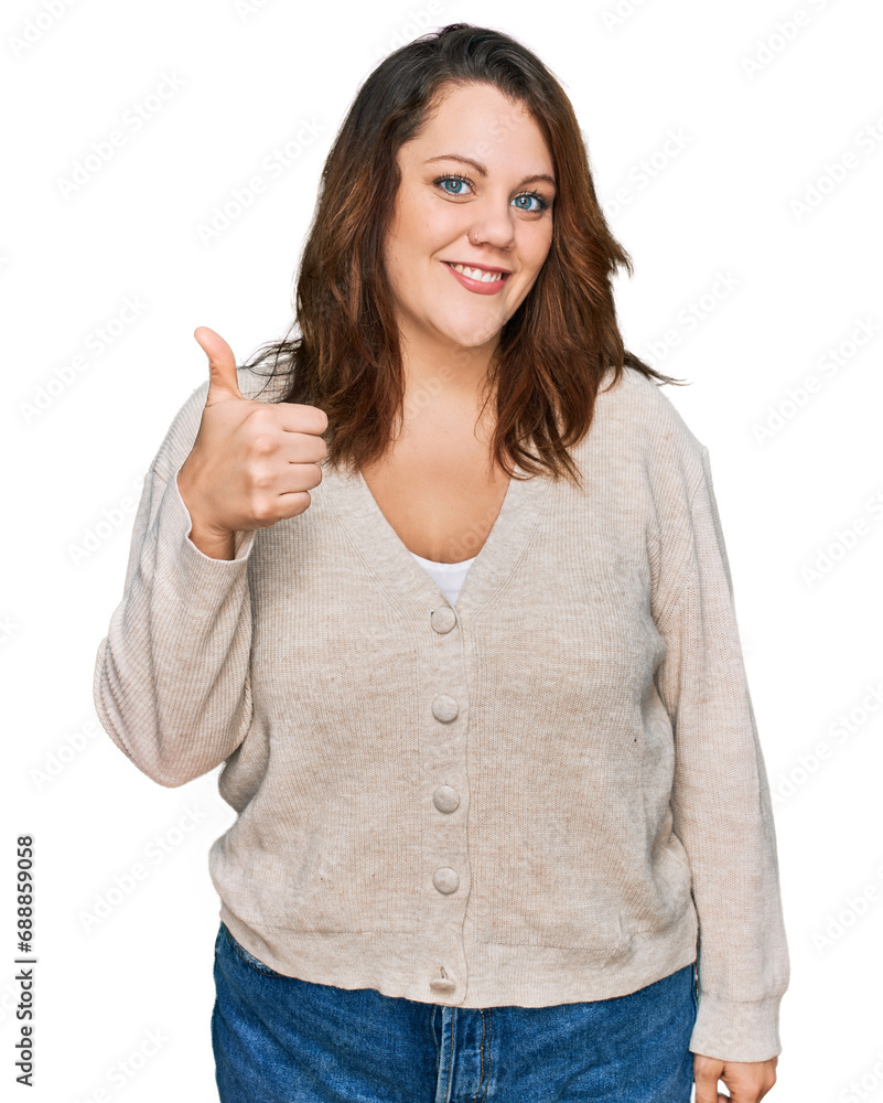 Young plus size woman wearing casual clothes doing happy thumbs up gesture with hand. approving expression looking at the camera showing success. Young plus size woman wearing casual clothes doing happy thumbs up gesture with hand. approving expression looking at the camera showing success.