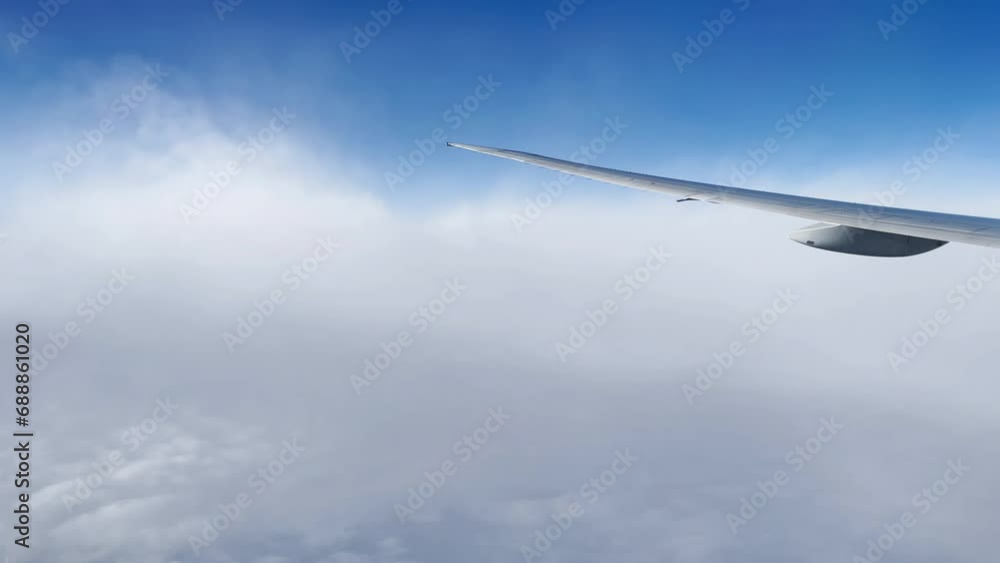 Airplane wing, view from window with beautiful sky and clouds Airplane wing, view from window with beautiful sky and clouds
