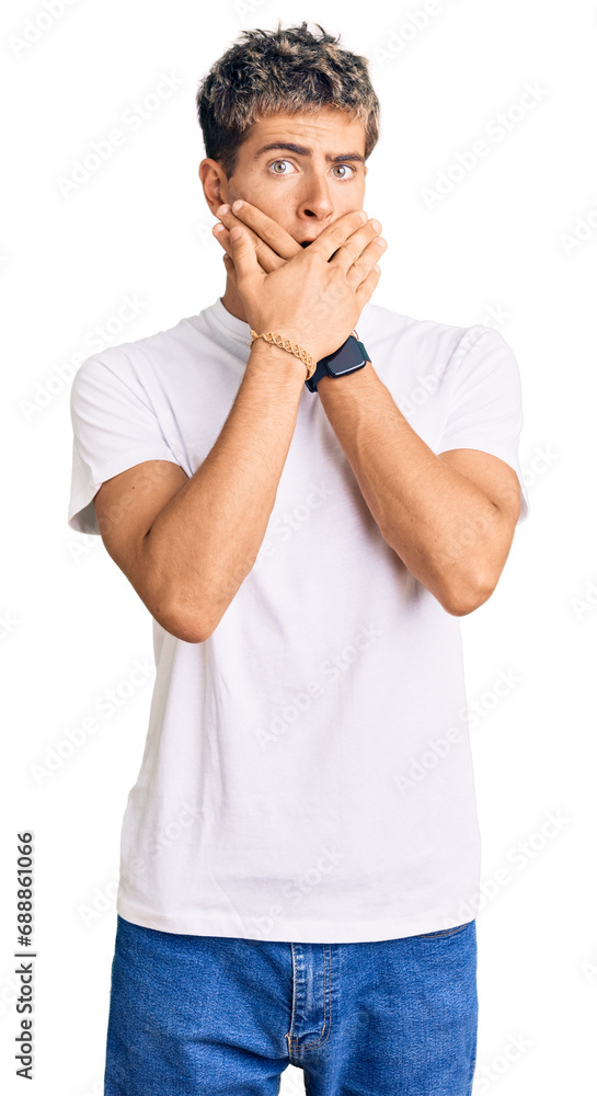 Young handsome man wearing casual white tshirt shocked covering mouth with hands for mistake. secret concept. Young handsome man wearing casual white tshirt shocked covering mouth with hands for mistake. secret concept.