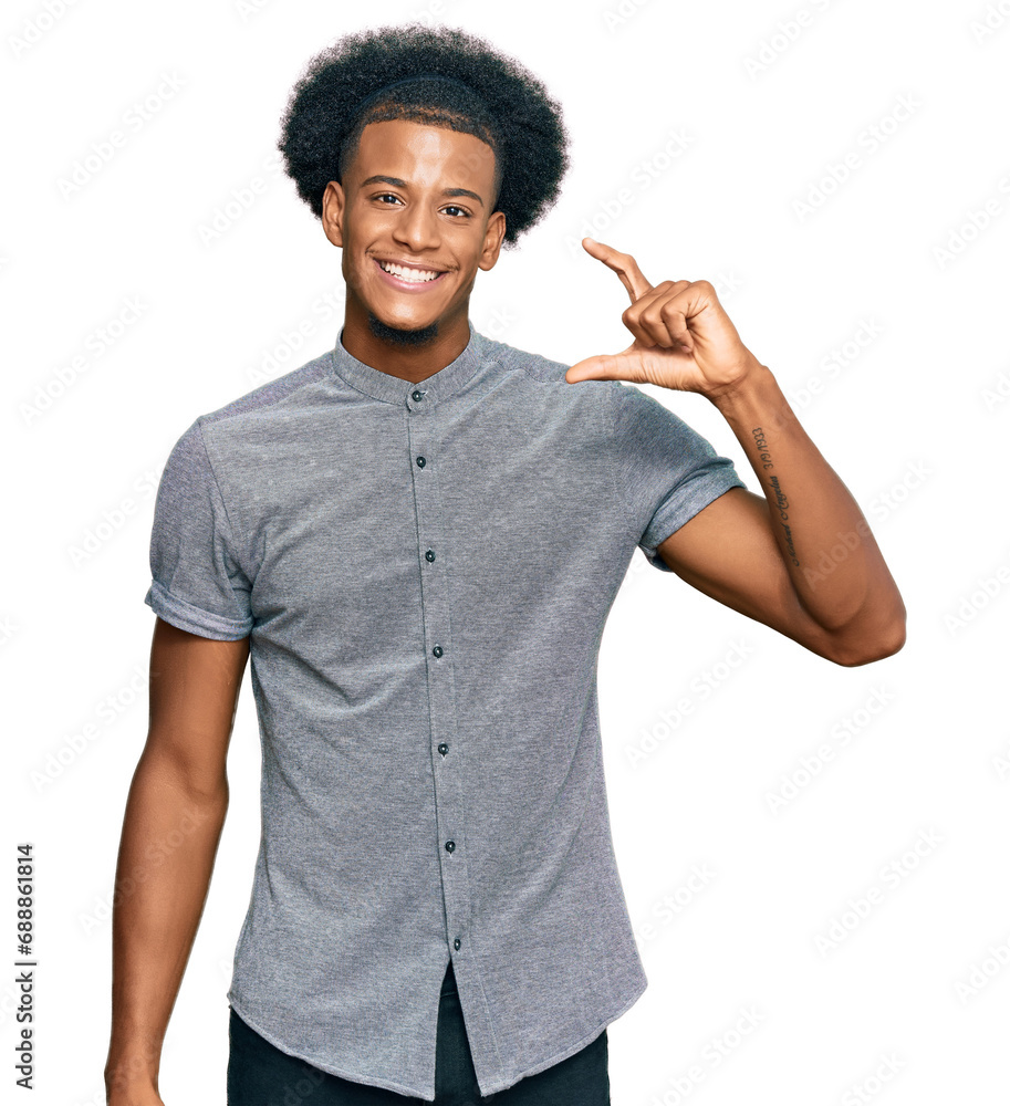African american man with afro hair wearing casual clothes smiling and confident gesturing with hand doing small size sign with fingers looking and the camera. measure concept. African american man with afro hair wearing casual clothes smiling and confident gesturing with hand doing small size sign with fingers looking and the camera. measure concept.