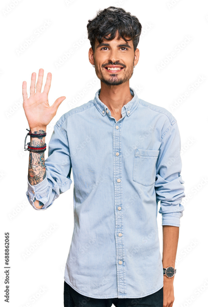 Young hispanic man wearing casual clothes showing and pointing up with fingers number five while smiling confident and happy.