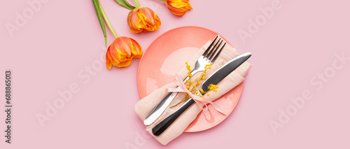 Beautiful table setting with fresh spring flowers on pink background