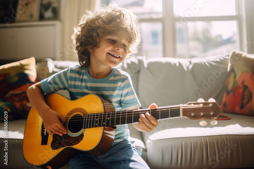 Cute little boy learning to play guitar in living room. Child having fun with music instrument. Art education for kids. photo